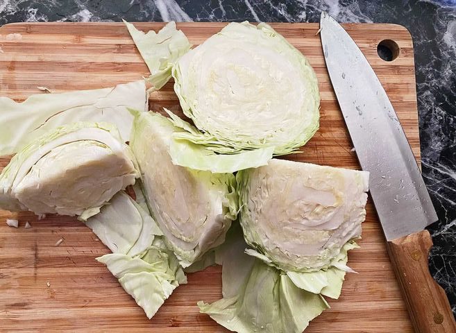 chopped cabbage with kitchen knife on a cutting board