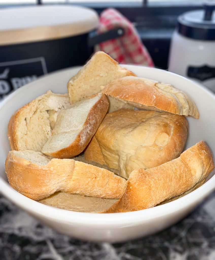 Large white ceramic bowl full of bread heels
